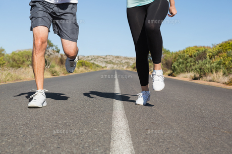 Fit couple running on the open road together FYI00002462 Fit couple running on the open road together FYI00002462