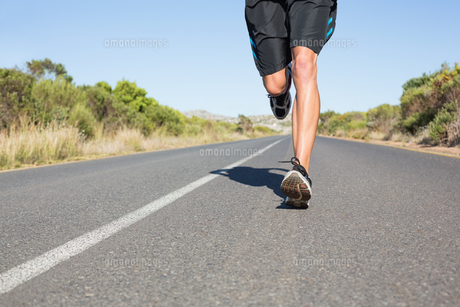 Fit man jogging on the open road FYI00002463 Fit man jogging on the open road FYI00002463