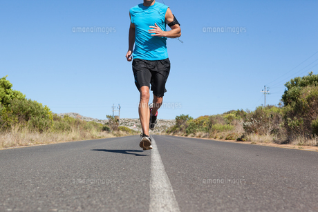Athletic man jogging on open road FYI00002494 Athletic man jogging on open road FYI00002494