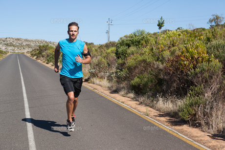 Athletic man jogging on open road FYI00002501 Athletic man jogging on open road FYI00002501