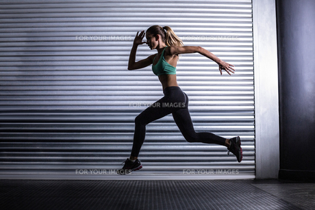 Muscular woman running in exercise room FYI00009062 Muscular woman running in exercise room FYI00009062