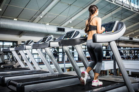 Rear view of woman jogging in treadmill FYI00010175 Rear view of woman jogging in treadmill FYI00010175