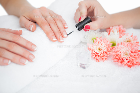 Woman applying nail varnish to finger nails FYI00488828 Woman applying nail varnish to finger nails FYI00488828
